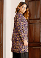 Model standing in side pose wears cotton long sleeve tunic with two buttons and mandarin collar