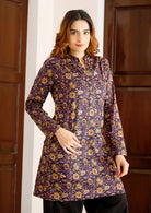 Woman wears lightweight, long cotton tunic with full sleeves in dark purple based floral print.