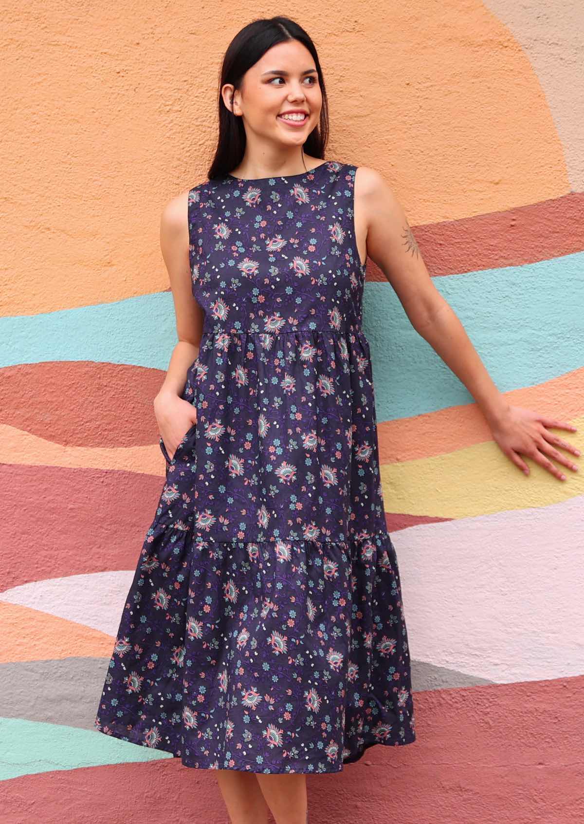 Model wearing Indian Cotton floral print dress with hand in pockets