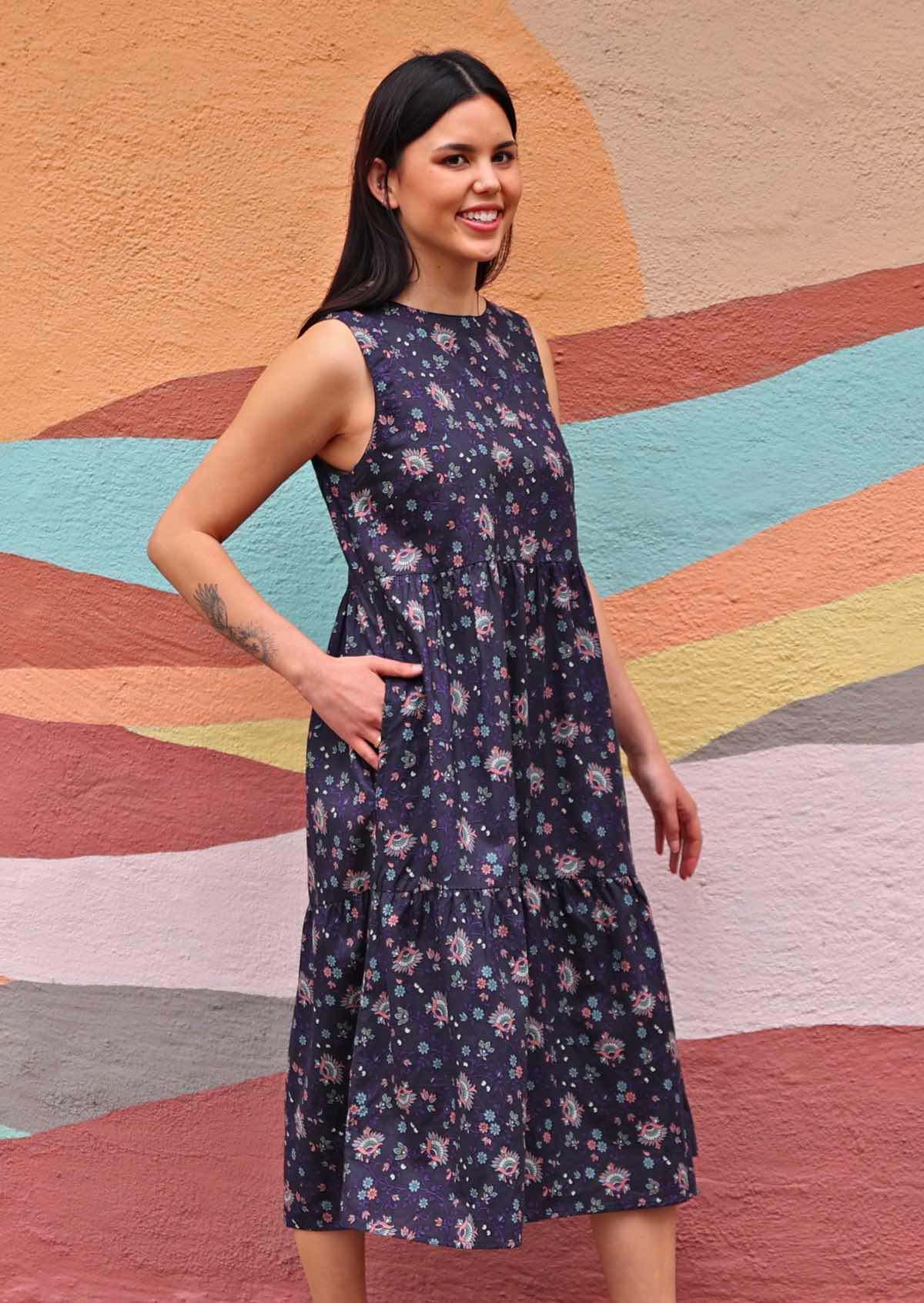 Model wearing Indian Cotton floral print dress with hand in pocket side view