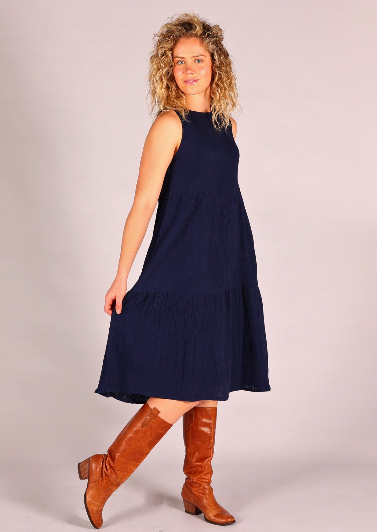 Sleeveless dress with high round neckline and tiers