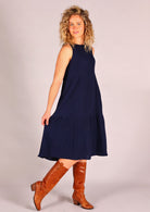 Sleeveless dress with high round neckline and tiers