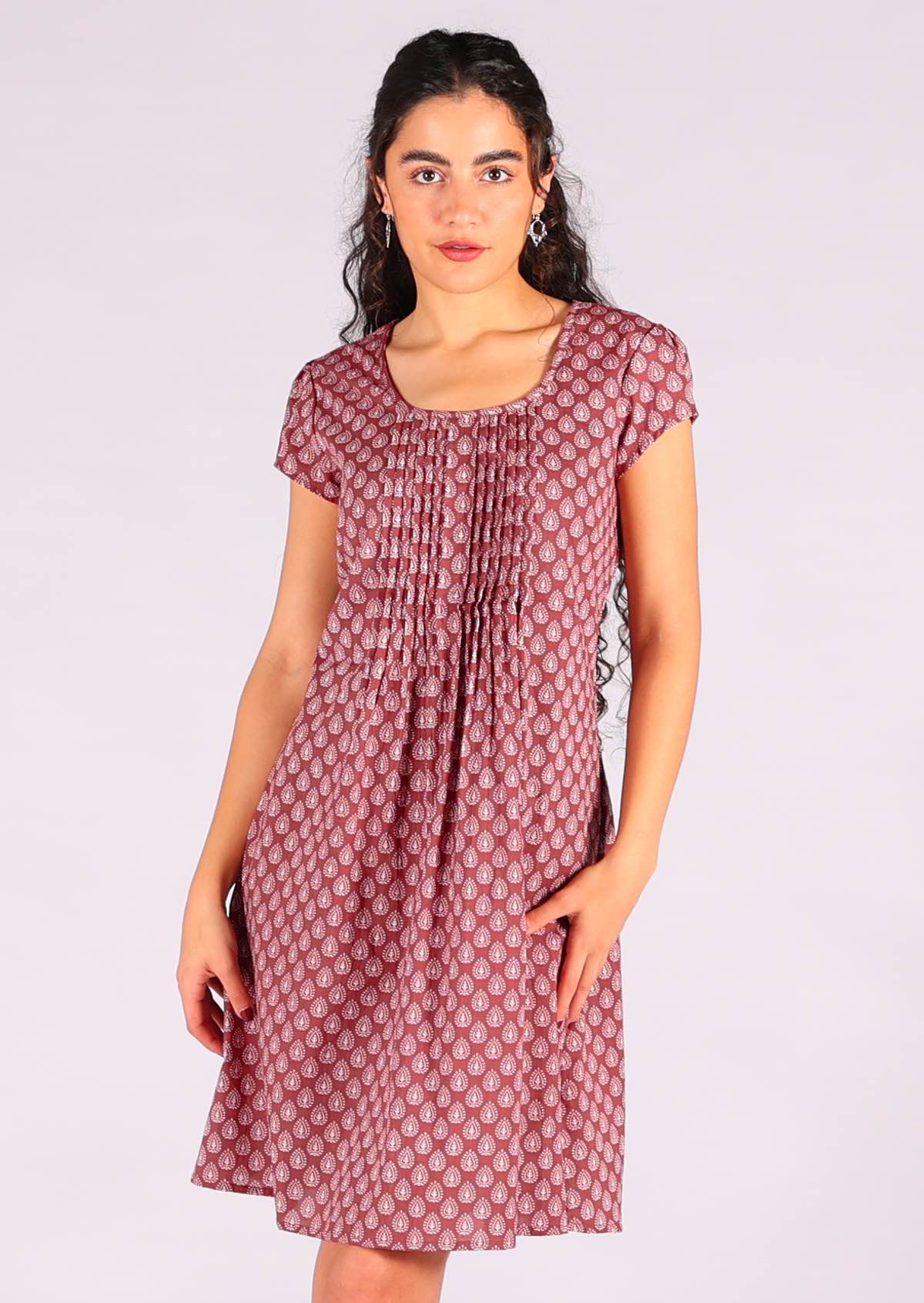 Model standing wearing 100 percent cotton short sleeve sundress with lining in dark terracotta
