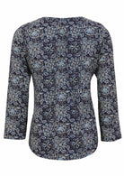 Back image of long sleeve cotton top with navy blue based floral print.