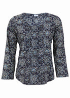 Lightweight 100% cotton top showcasing a simple round neckline, long sleeves and pleats across the bodice.