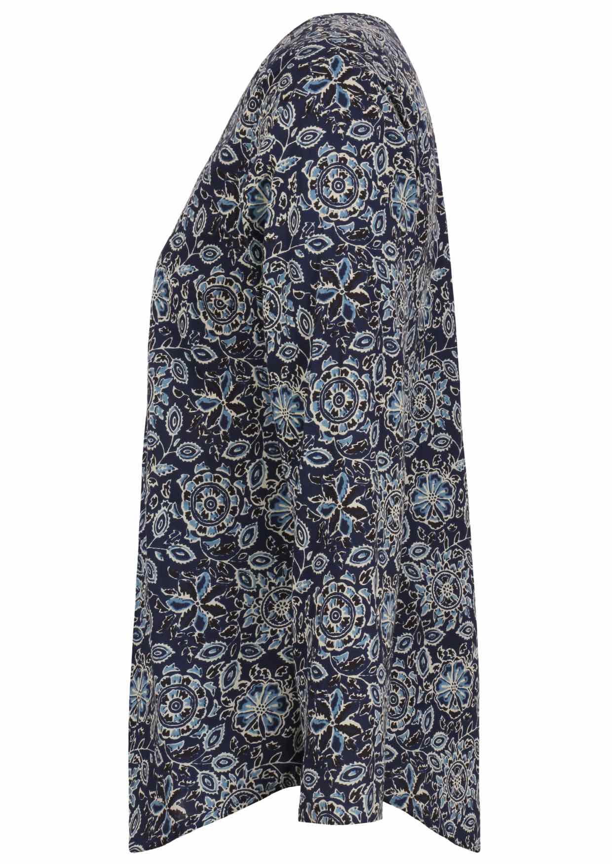 Side image of long sleeve cotton top with navy blue based floral print.