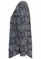 Side image of long sleeve cotton top with navy blue based floral print.