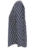 Side image of long sleeve cotton top with navy blue based floral print.
