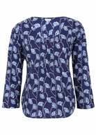 Lightweight 100% cotton top showcasing a simple round neckline, long sleeves and pleats across the bodice.