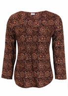 Lightweight 100% cotton top showcasing a simple round neckline, long sleeves and pleats across the bodice.
