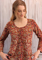 Woman wearing long sleeve earthy toned Indian print cotton blouse scoop neck with pleated detail 