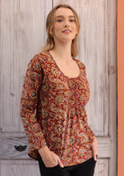 Woman wearing long sleeve earthy toned Indian print 100% cotton blouse 