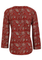 Back image of long sleeve cotton top with red based floral print.
