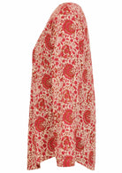 Side image of long sleeve cotton top with cream based floral print.