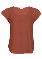 Rust orange 100% cotton short sleeve top with scoop neckline and tiny pleated detail across the bust.
