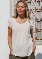 woman wearing 100% cotton top with scoop neck in an outdoor setting