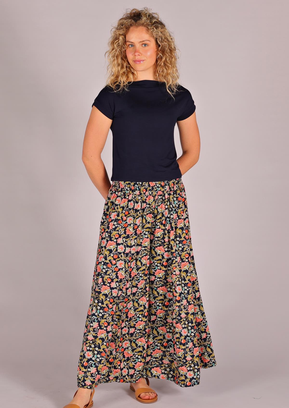 Model with hands behind back wearing rayon wide legged womens palazzo pant with elastic waist