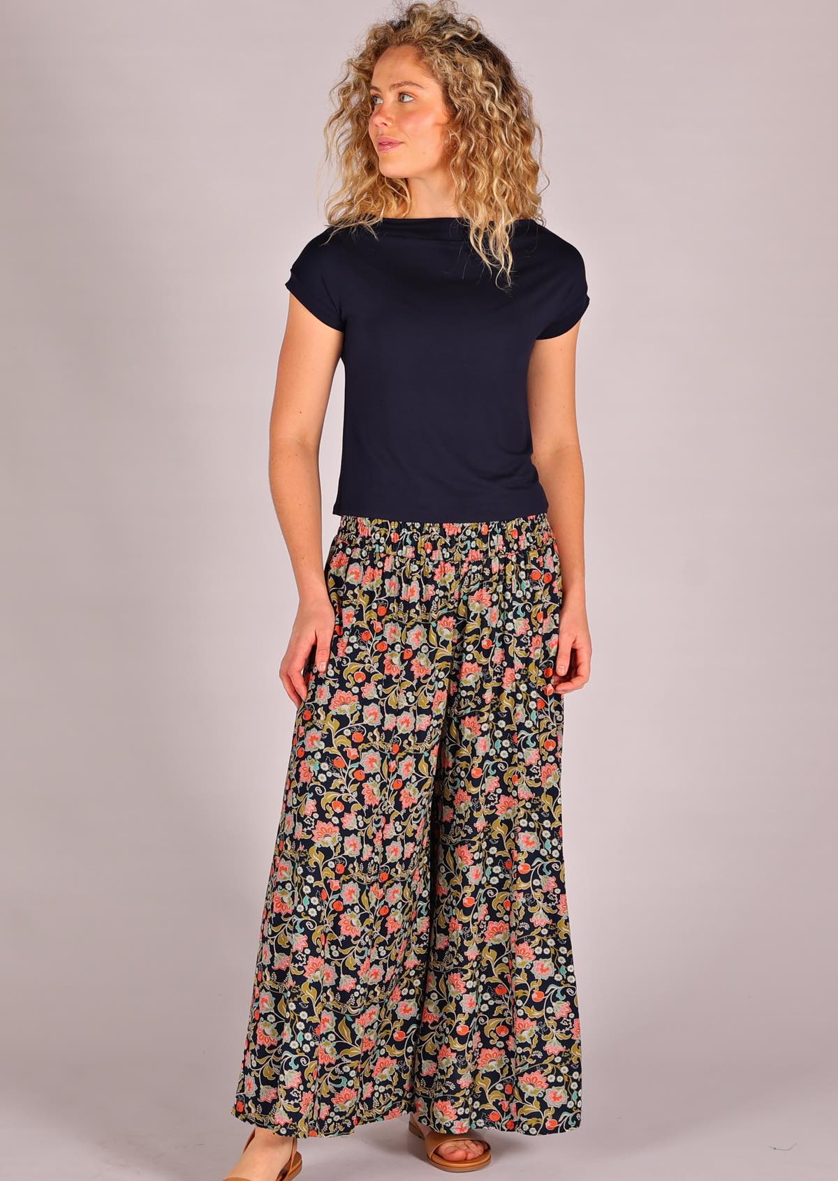 Model facing to the side wearing rayon wide legged womens palazzo pant with elastic waist