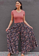 Woman wearing Indian print dark rayon super wide leg pants with shirred waist band