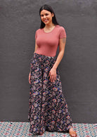 Woman wearing Indian print dark rayon wide leg pants with shirred waist band