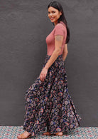 side view of Woman wearing Indian print dark rayon wide leg pants with shirred waist band