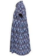 Side view of blue tulip print on dark blue base cotton relaxed fit collared short sleeve dress with hidden side pockets