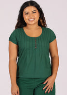 Green cotton blouse on woman with olive skin