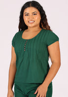 Green cotton blouse with cap sleeve on woman