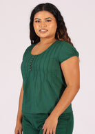 Green cotton blouse on woman with dark hair