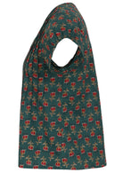 Side view of green based floral print 100% cotton top with cap sleeves