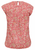 Back view of cotton sleeveless top with a muted floral print with a dusky pink base, with button closure at the nape of neck