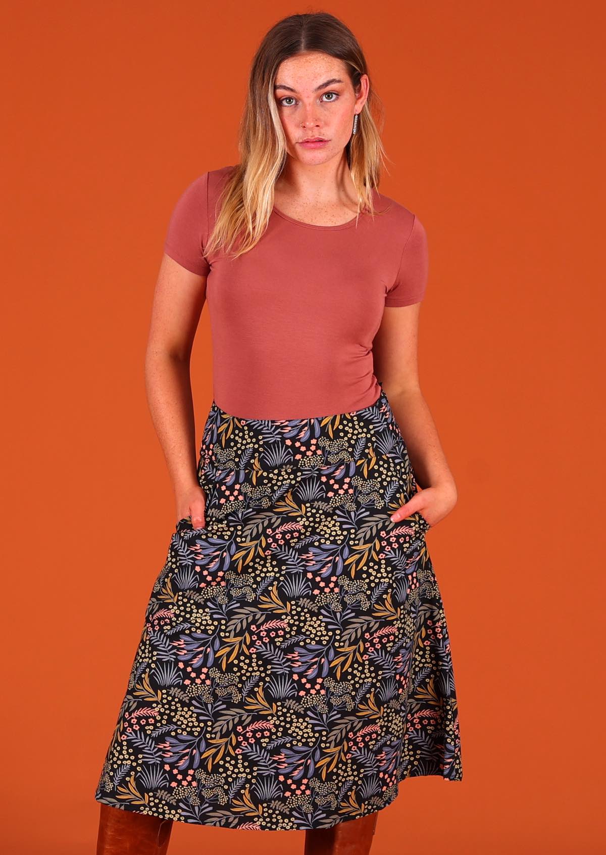 Model poses in generous A-line cotton over the knee skirt with pockets