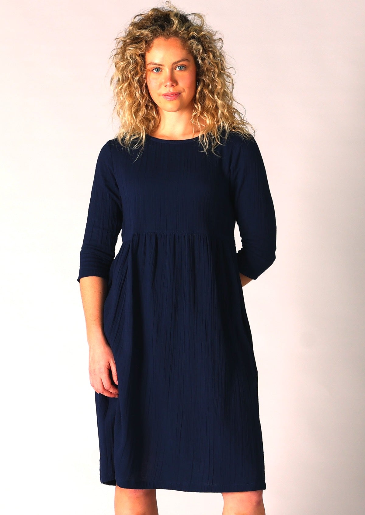 Model wears super comfortable cotton gauze dress in dark blue