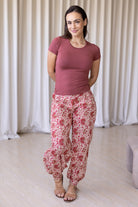 Woman wearing floral cotton wide leg pants with buttoned ankle paired with pink basic top