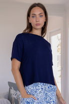 Woman wearing a navy blue relaxed fit stretch rayon t-shirt with a high neckline
