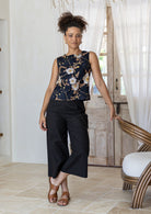 Model wears 100% cotton relaxed fit sleeveless top in black based floral print.