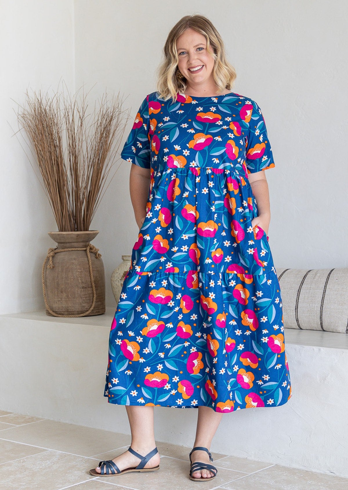 Woman wearing a 100% cotton dress in royal blue based floral print 