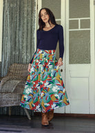 Woman standing wears 100% cotton button through skirt.