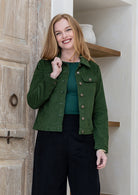 Woman wearing a 100% cotton corduroy jacket paired with plain black pants