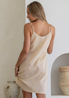Beige pure cotton slip with adjustable straps, shown on model from behind