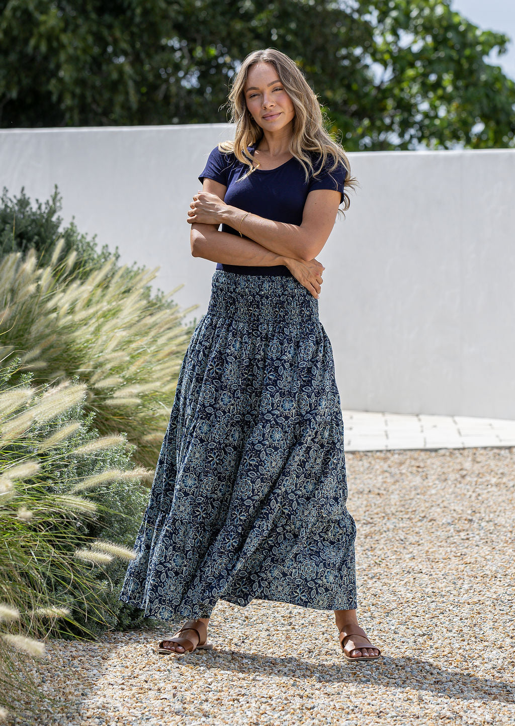 Model is wearing 100% cotton tiered maxi skirt in navy blue based floral print with wide elasticated waistband.
