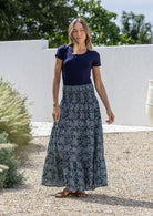 woman wearing a simple navy top and 100% cotton maxi skirt in navy blue based floral print. 