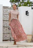 Model flaunting rose pink based floral print cotton maxi skirt with a wide shirred elastic waistband.