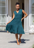 Front view of woman in the Ember Midi Dress Deep Teal with buttoned bodice