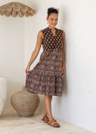 Woman wearing a brown Indian Cotton patterned dress with a full skirt