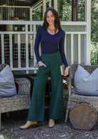 Woman in a cotton corduroy pants in botanical garden paired with navy blue basic top