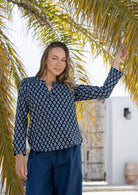 Woman wearing a 100% cotton top in navy blue based floral print with V neckline