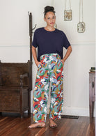 Woman wears 100% cotton wide leg pants with elastic waist, pockets and pleated ankles 