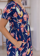Close up picture of woman wearing a 100% cotton bold botanic printed dress 