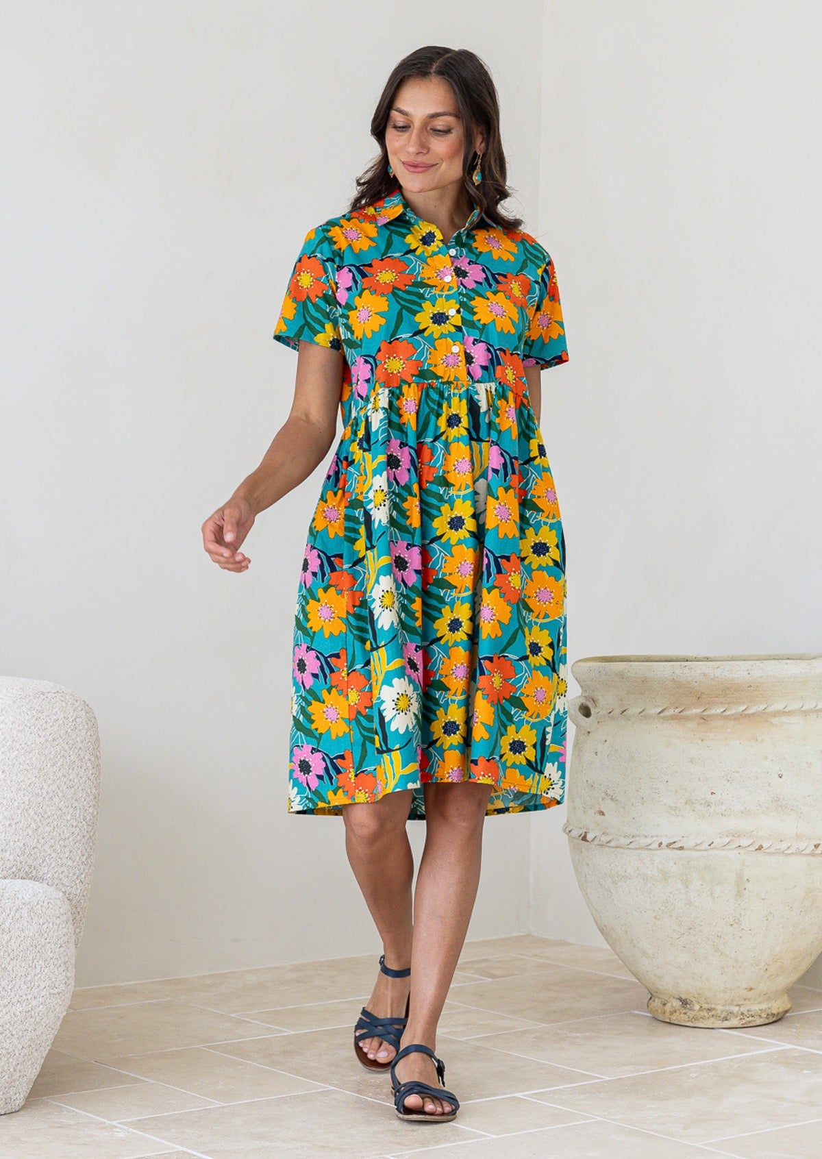 Woman wearing a 100% cotton Teal floral print shirt dress with short sleeves and collar. 